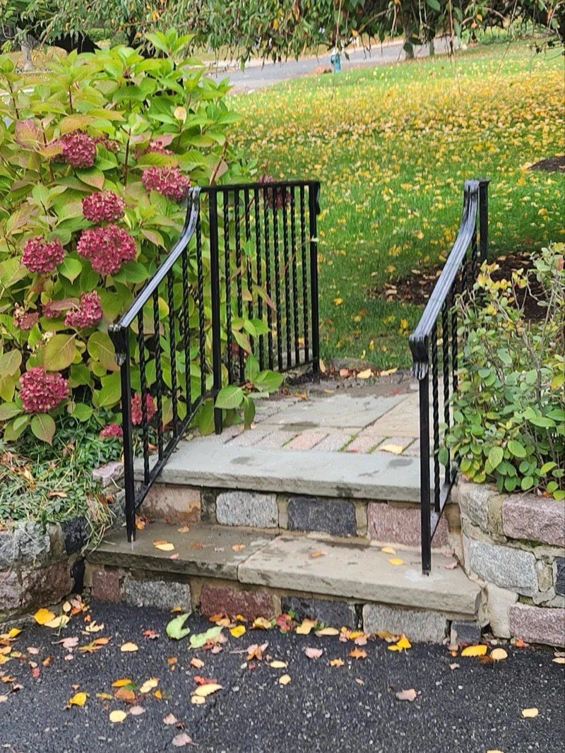Stone front steps with wrought iron railings